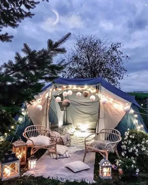 Cozy outdoor tent setup with lights and seating