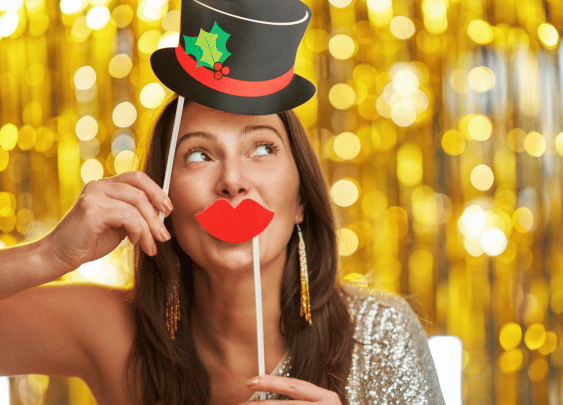 Woman with top hat and lips prop at a photo booth