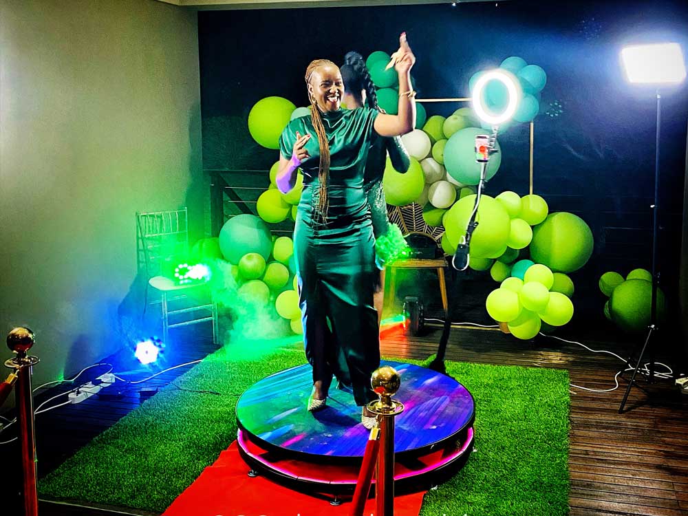 Woman in green dress posing on a 360 photo booth