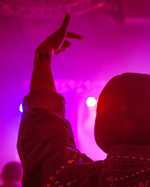 Audience member raising hand at a live event