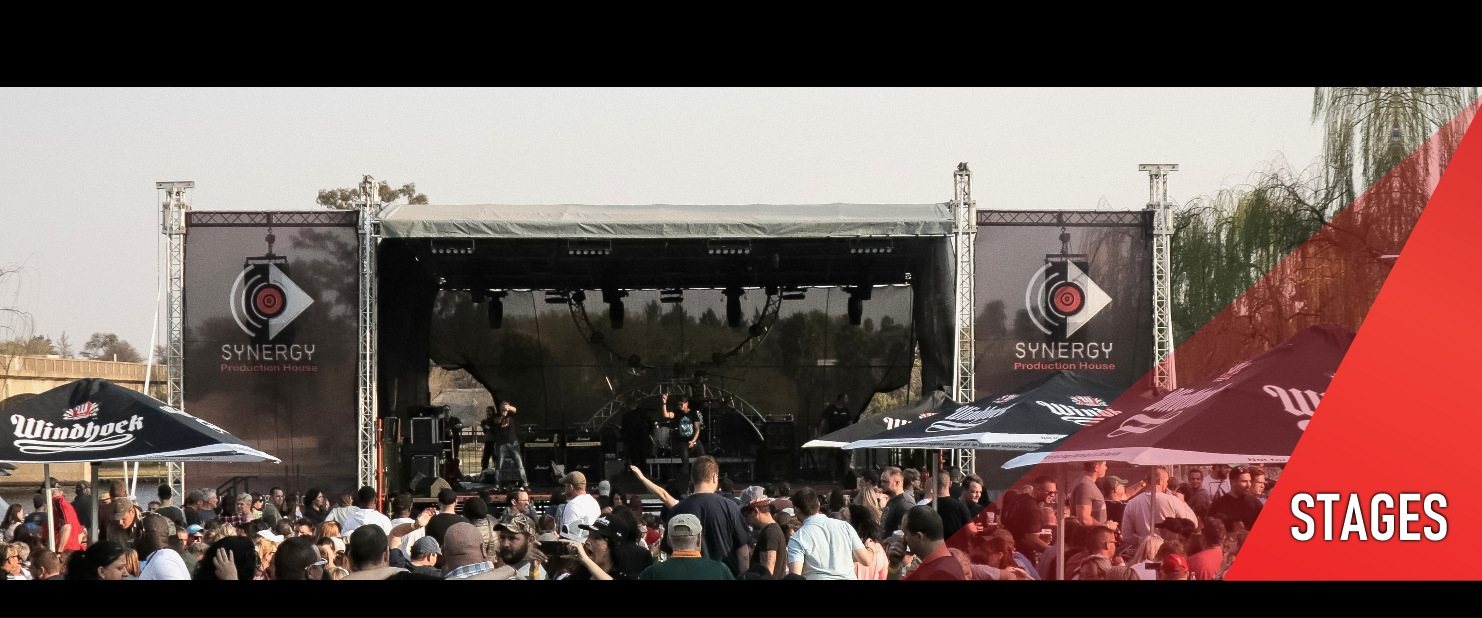 Large event stage with branded banners and crowd