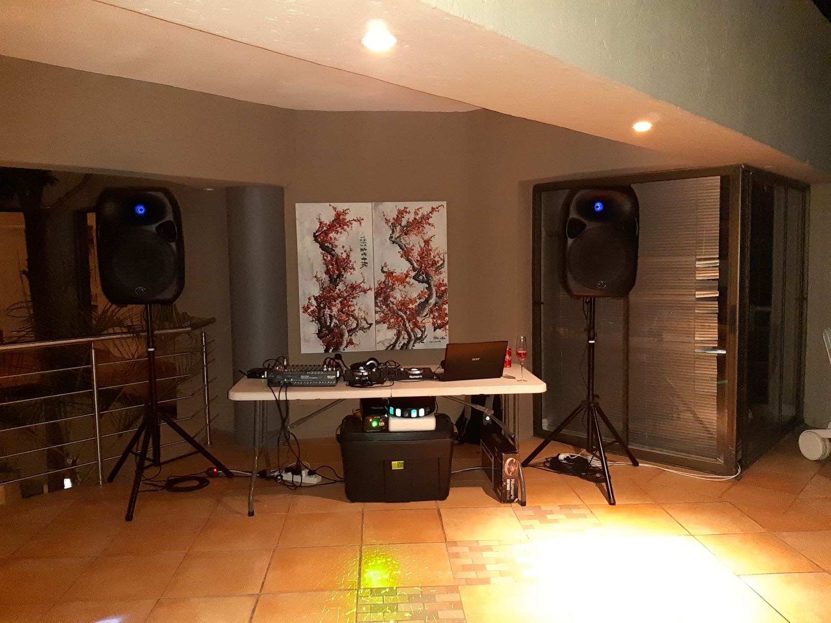 DJ equipment setup with speakers and mixer in a venue.