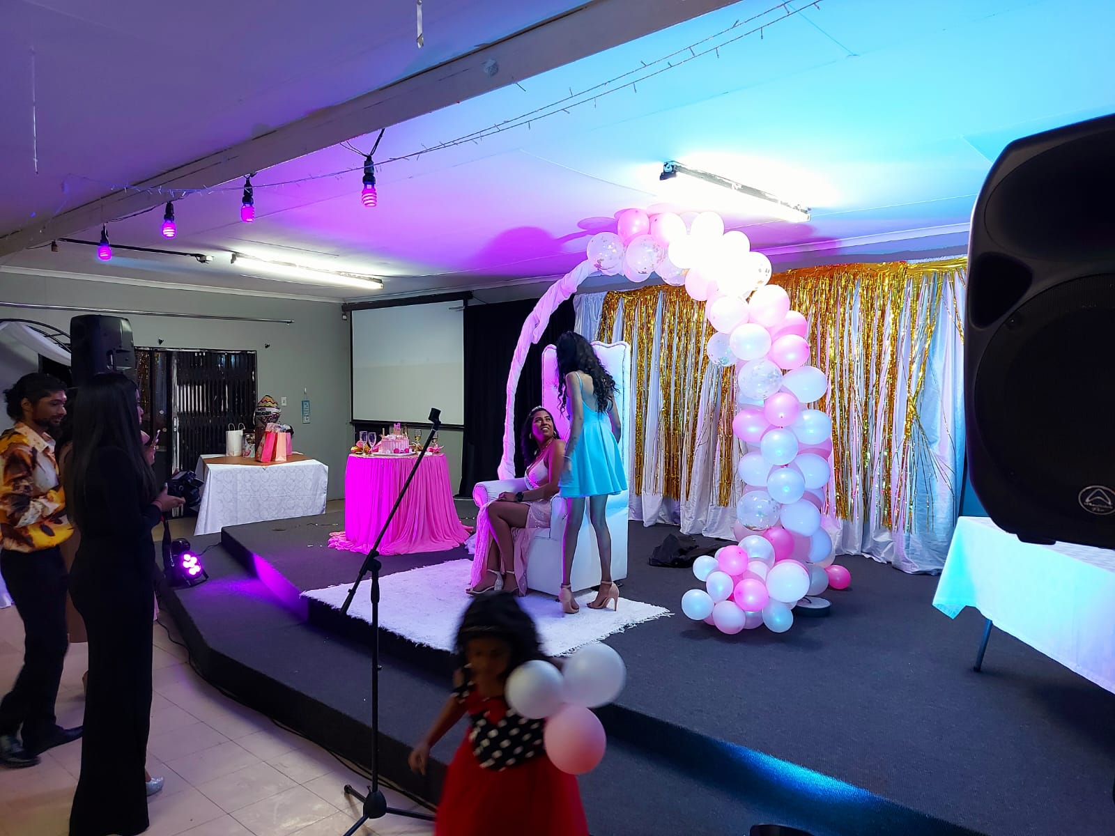 Event stage with balloon arch and decorative elements