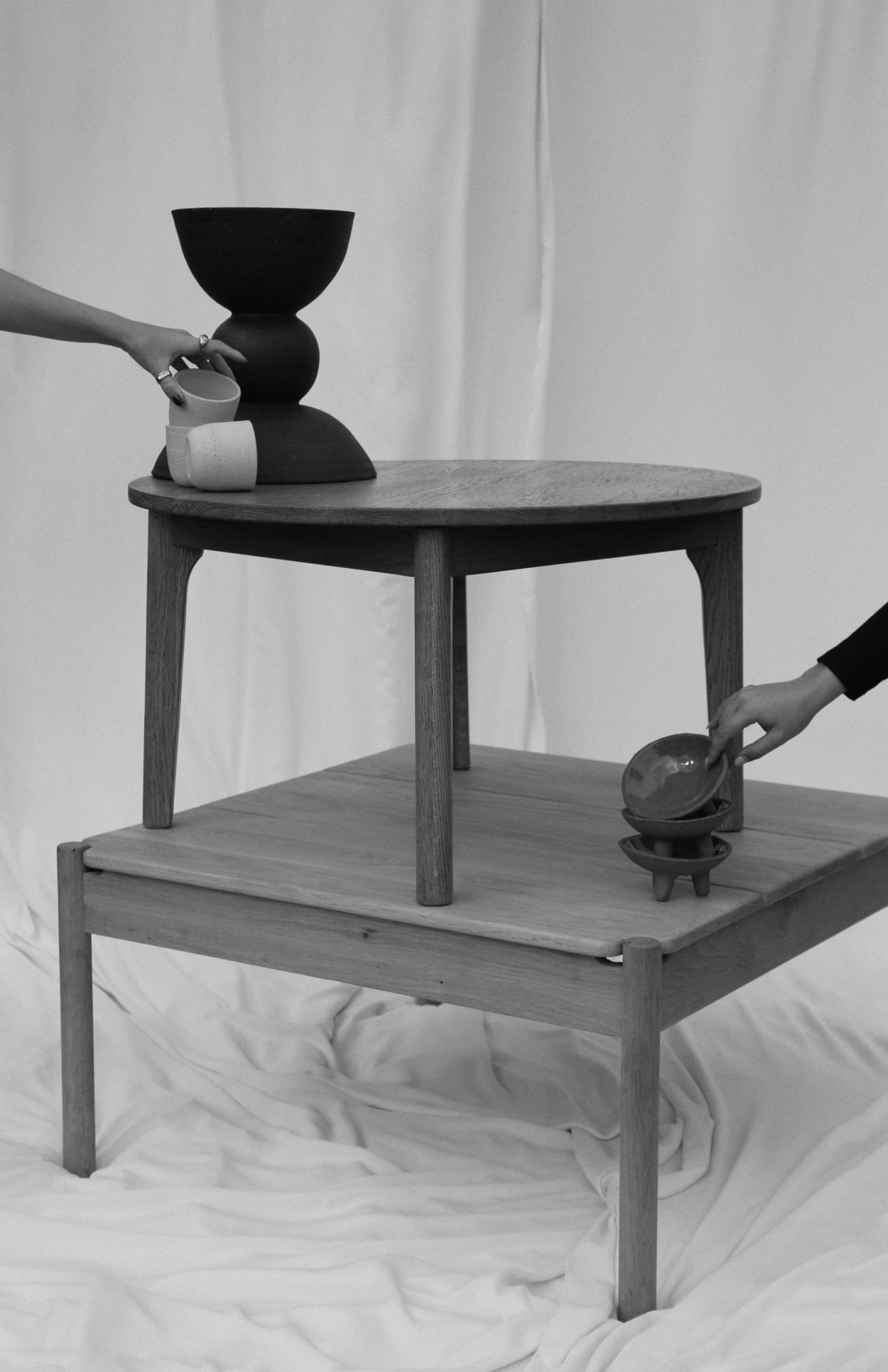 Two tables with handcrafted ceramic and wooden decor items