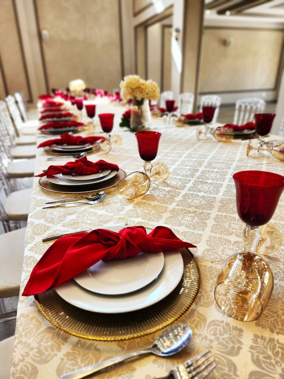 Elegant dining table with red napkins and glassware