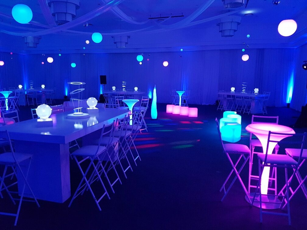 Colorful LED furniture setup with various lighted tables and chairs