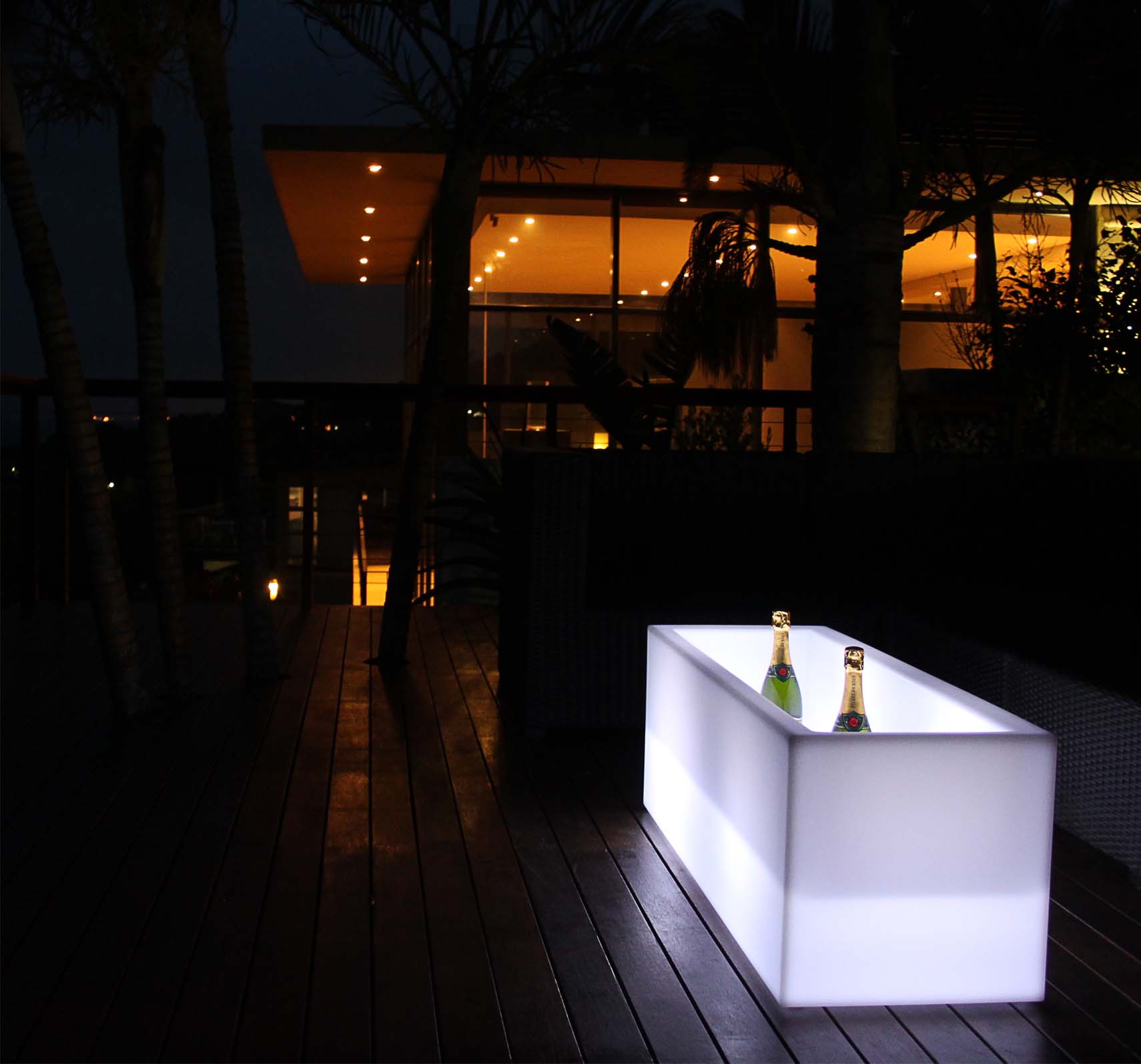 LED ice bucket glowing in a stylish setting with drinks inside.
