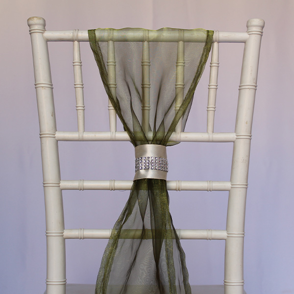 White bamboo chair with green chiffon drape and rhinestone tie