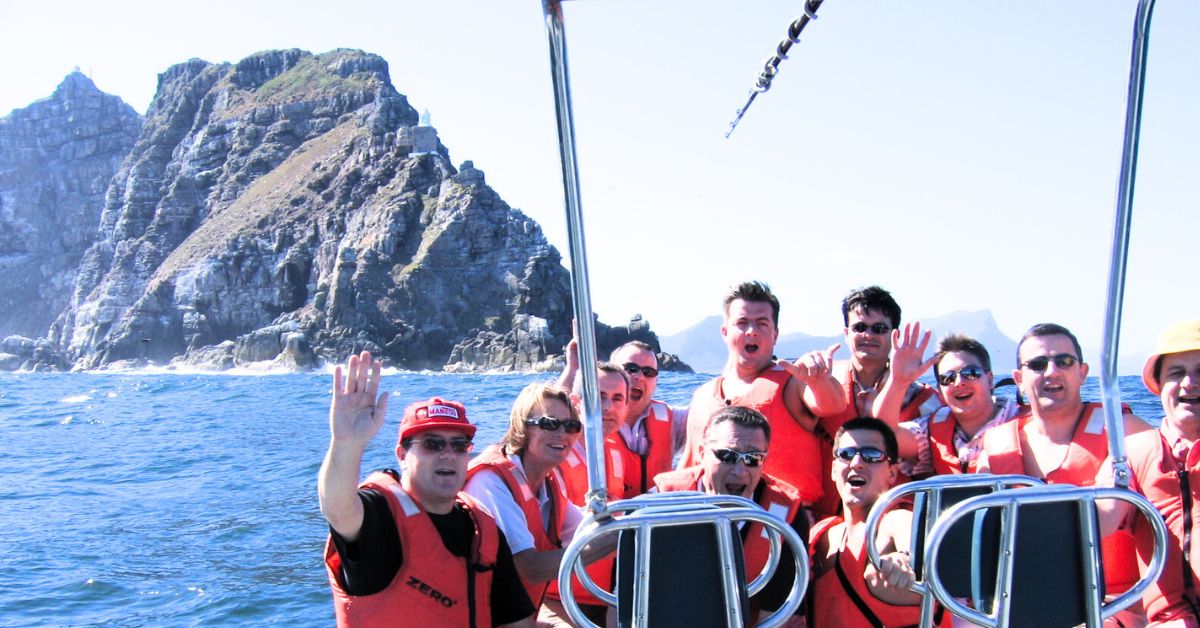 Group of people on a boat wearing life jackets in Hout Bay.