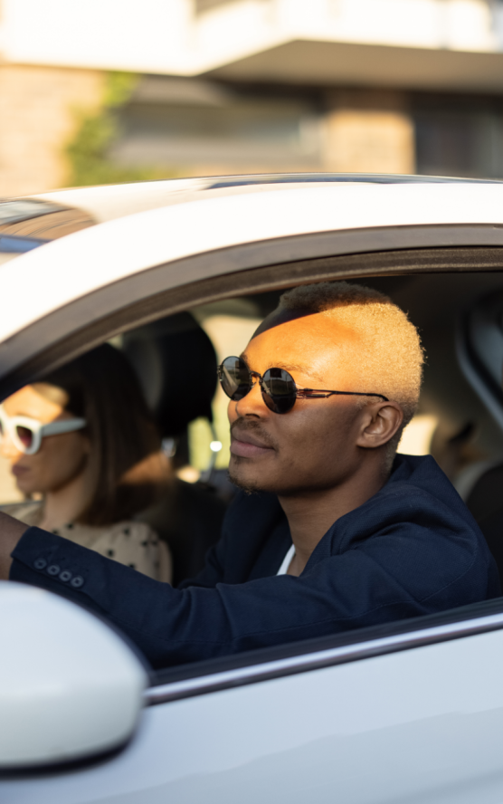 Elegant driver in a classic car with a passenger.