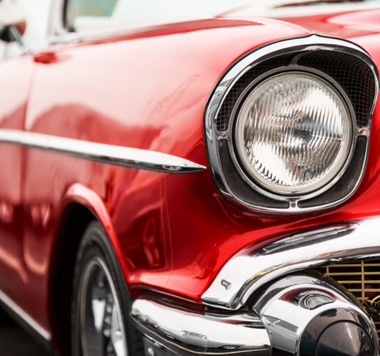 Close-up of a red vintage car's front end