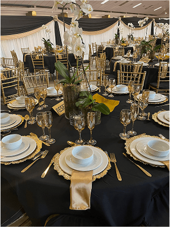 Luxurious black and gold table setting for an event