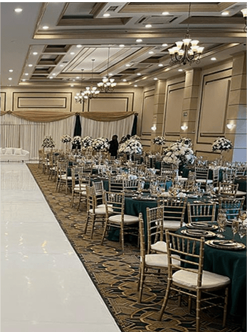 Banquet hall with green tablecloths and floral centerpieces
