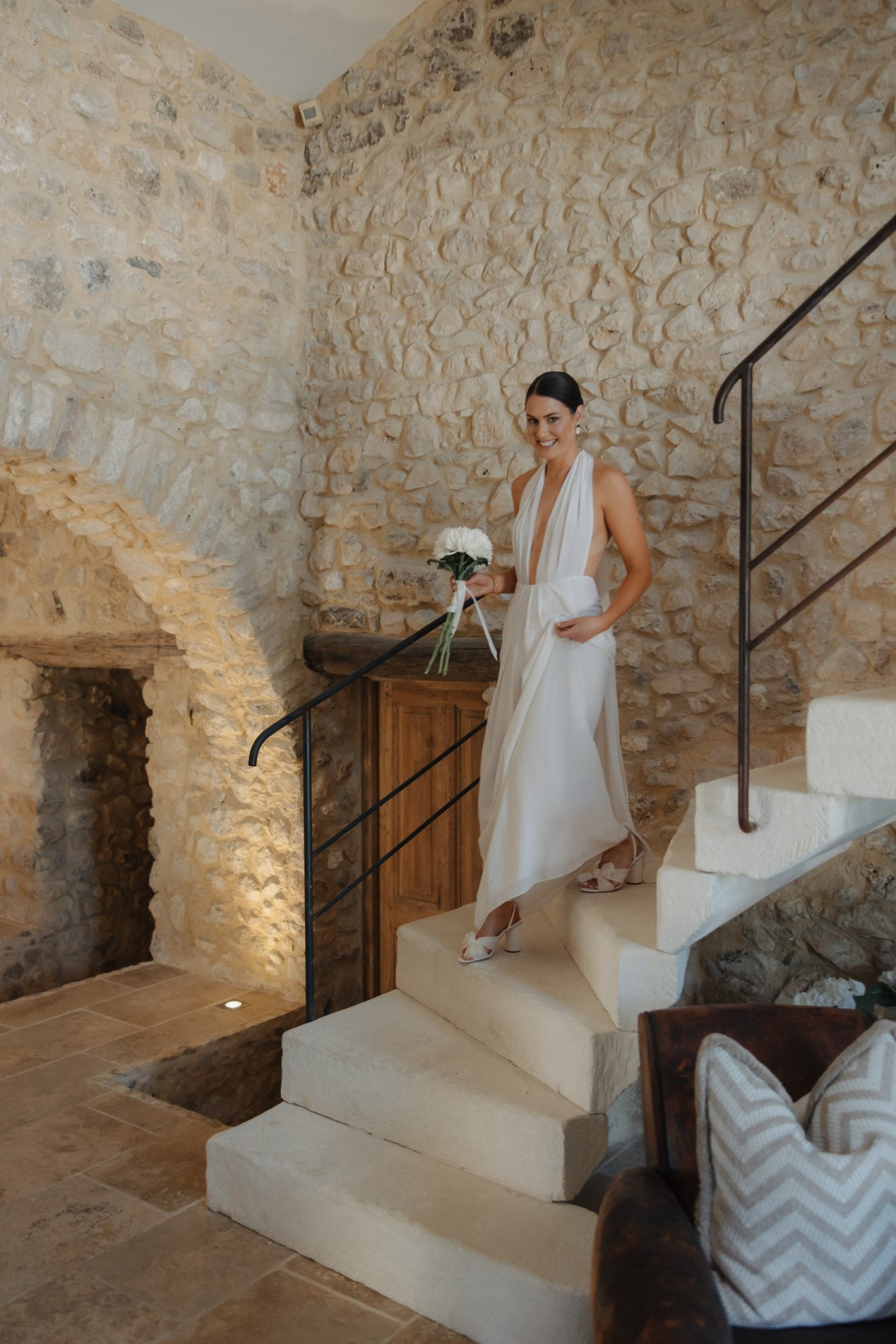 Bride walking down a staircase in a garden venue