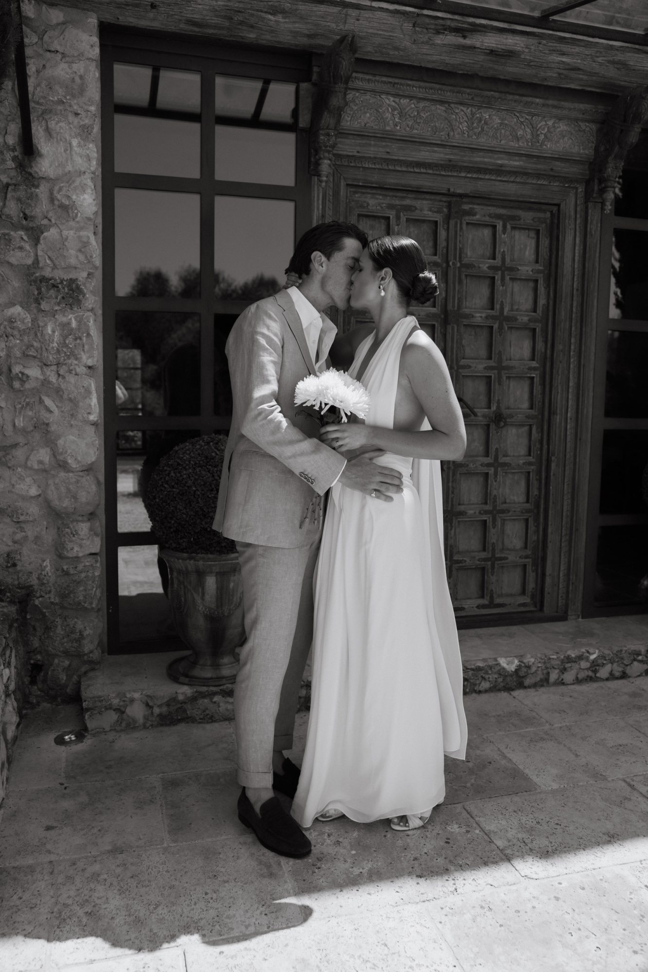 Couple sharing a kiss in a garden setting
