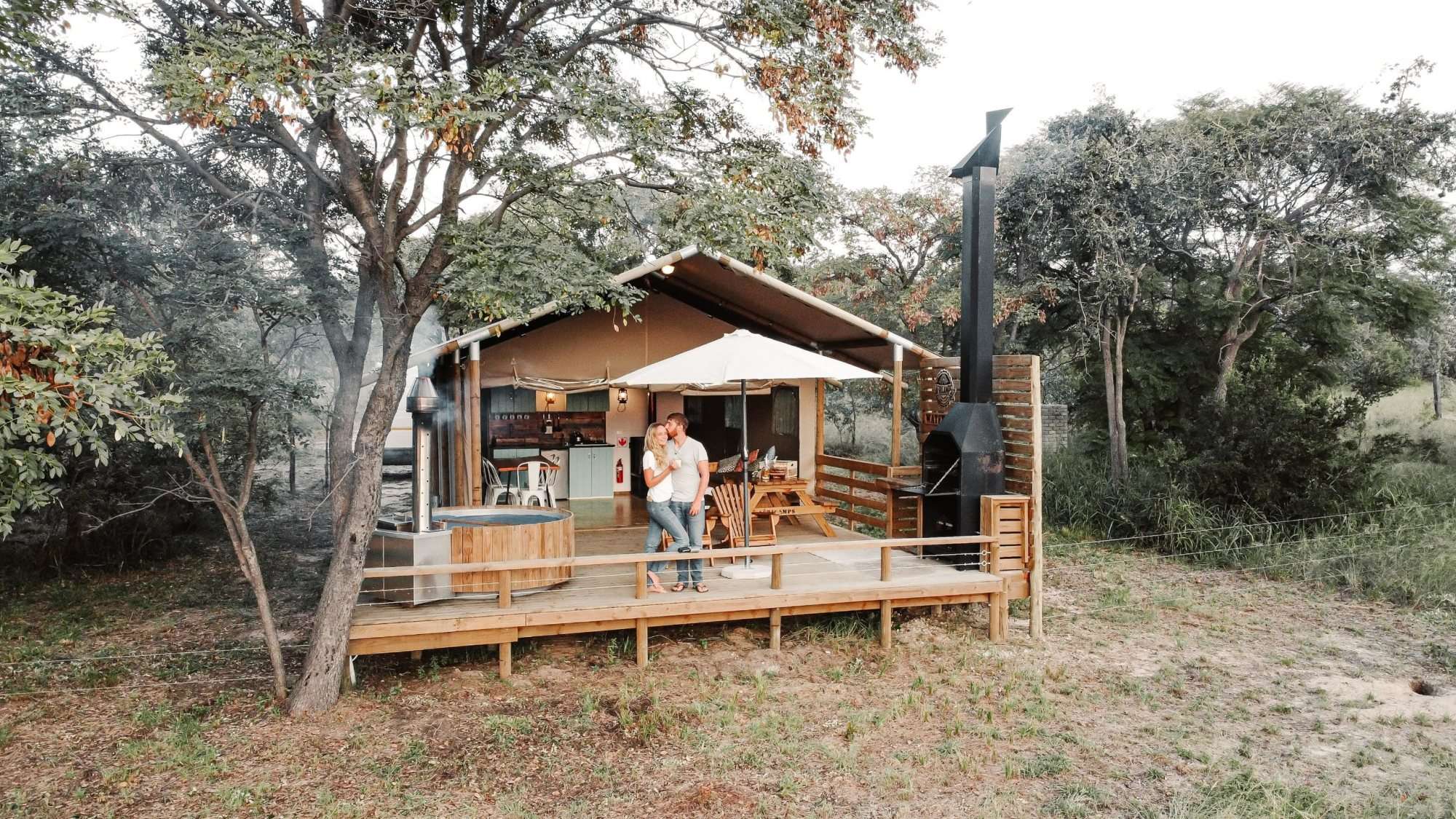 Glamping accommodation with wooden deck and outdoor seating