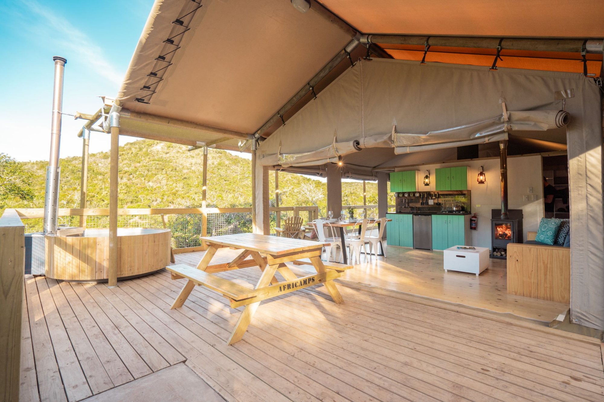 Interior of a glamping tent with dining area and kitchen