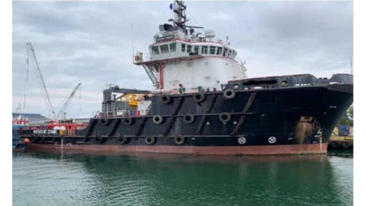 Image of a marine vessel in the water at a dock.