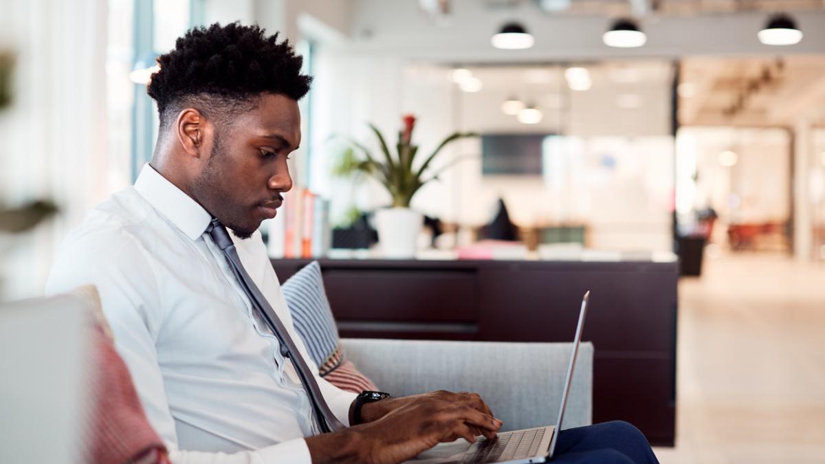 Man working on a laptop in an office setting