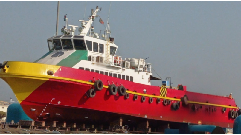 Brightly colored vessel docked at the waterfront
