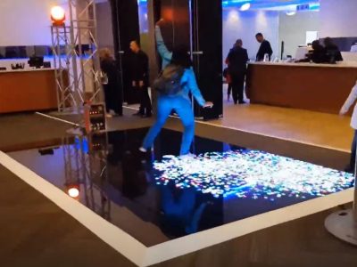 Person dancing on an interactive LED dance floor