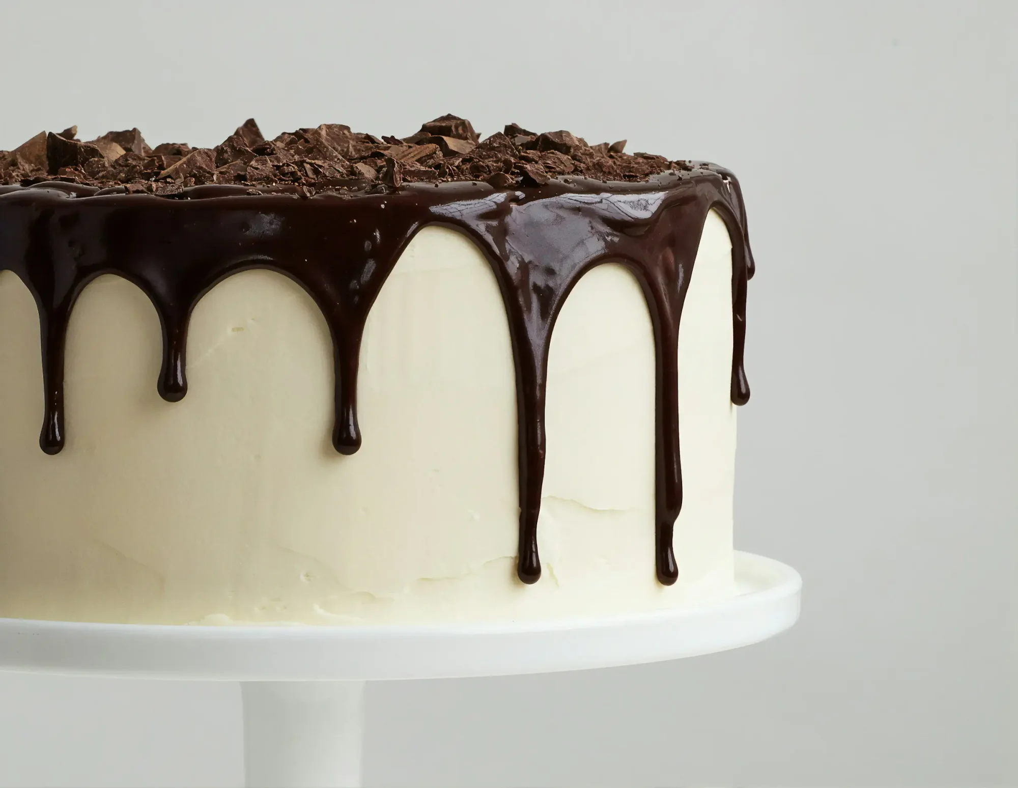 White cake with chocolate ganache and shavings on top