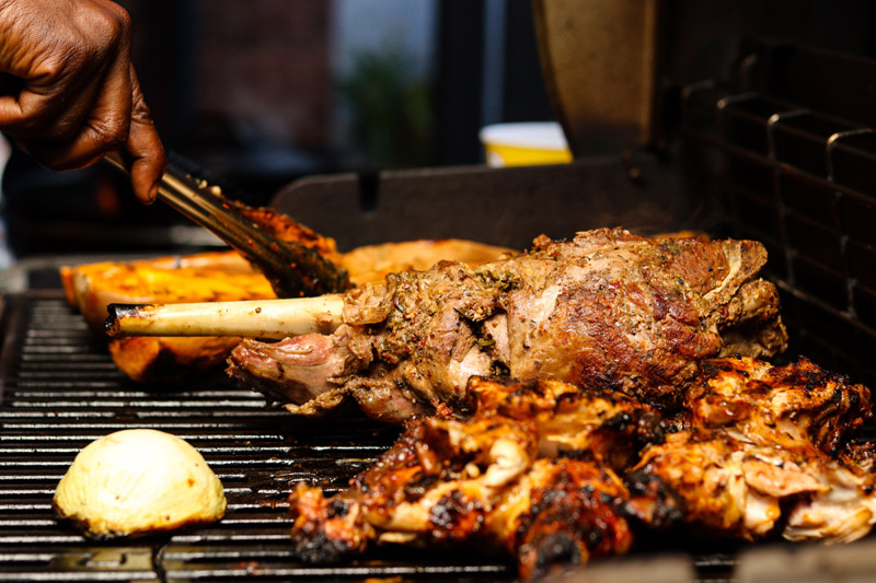 Grilled meats and onion on a barbecue grill