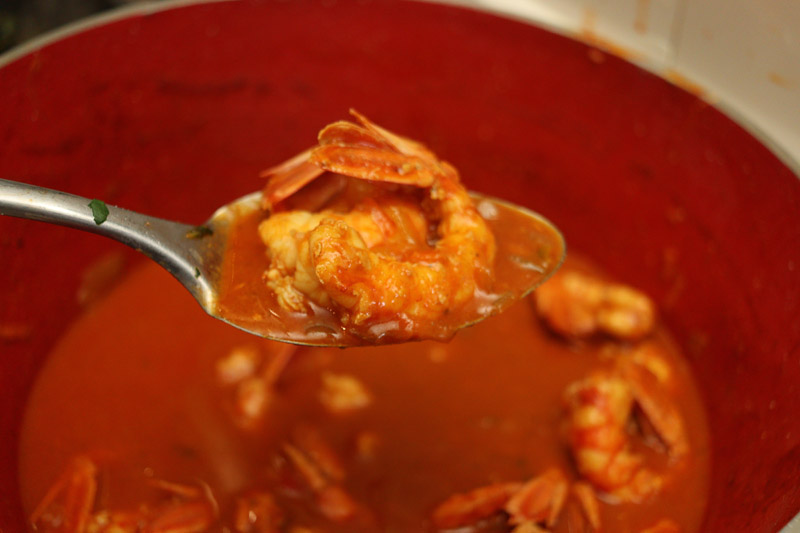 Close-up of seafood in a pot with a ladle