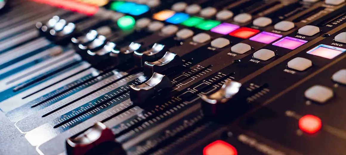 Close-up view of an audio mixing console with various controls