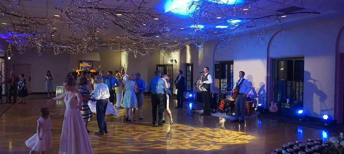 Uplighting setup illuminating a dance floor with warm colors