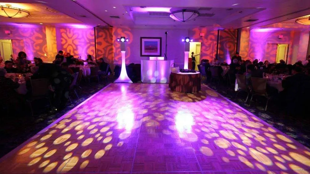 Illuminated dance floor with colorful uplighting in a venue