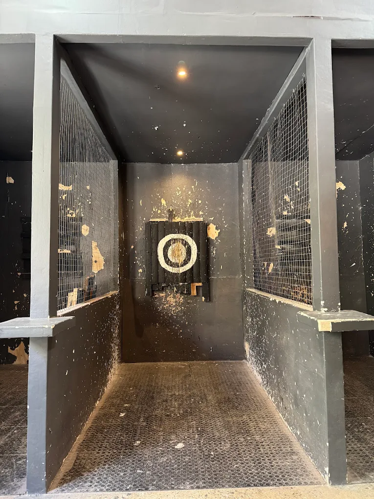 Axe throwing lane with target and dark walls
