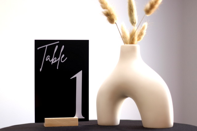 Table number one with a modern vase and dried floral arrangement