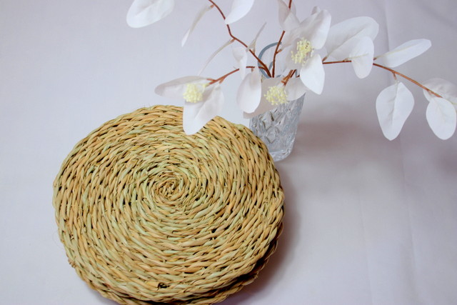 Natural woven placemats with a decorative vase