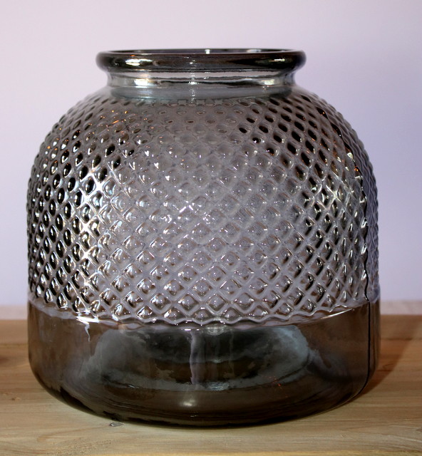 Textured glass vase with a patterned surface