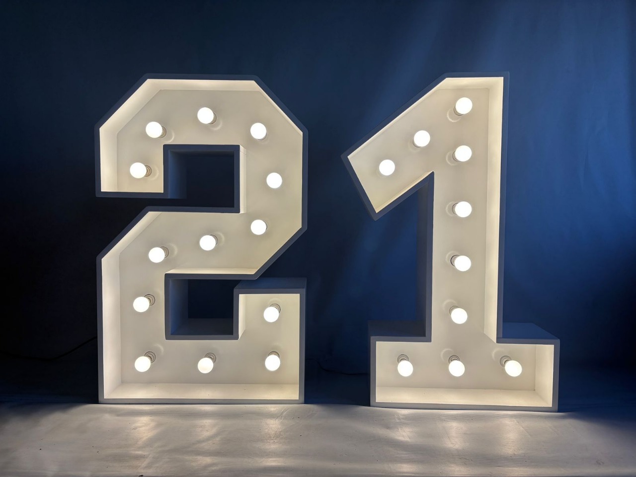 Large illuminated numbers '21' with bright bulbs
