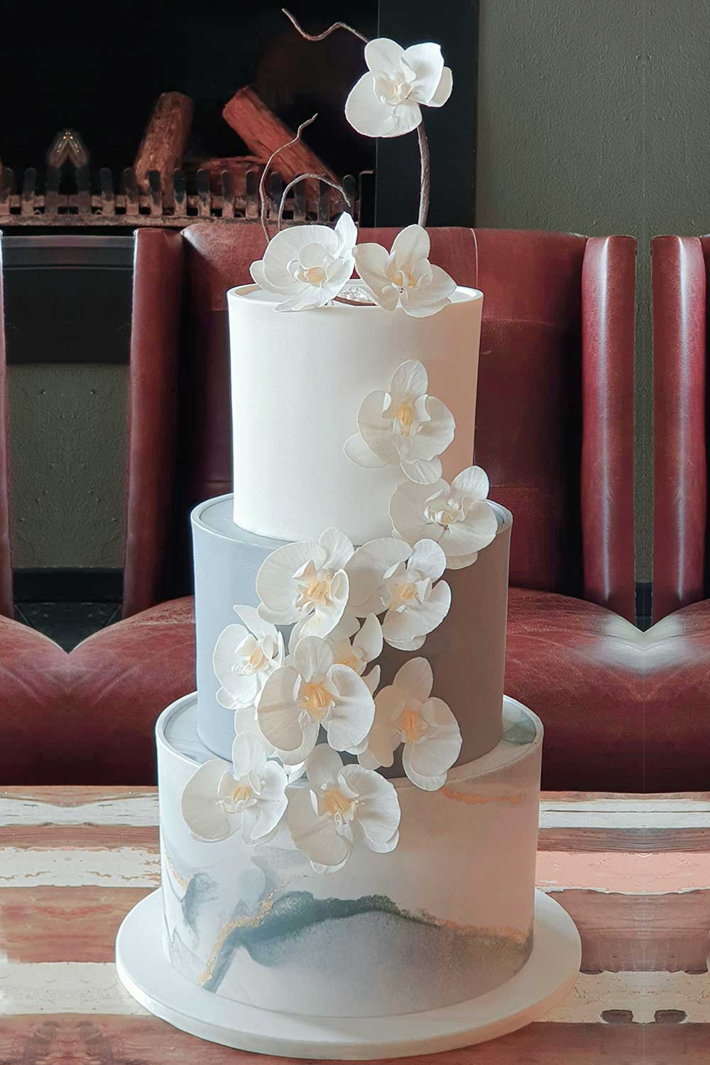Three-tier wedding cake with sugar orchid decorations