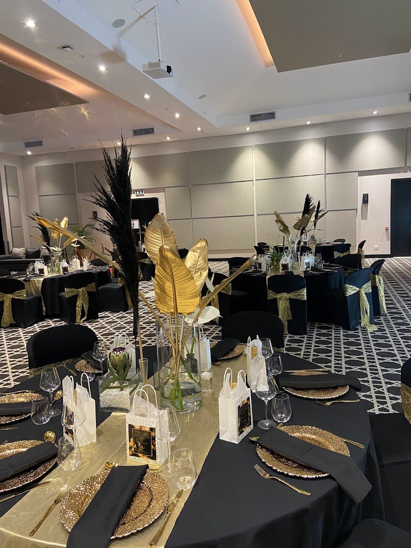Sophisticated black and gold table setup for an event