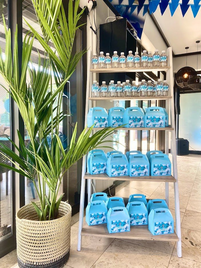 Display of blue party favour boxes and bottled water