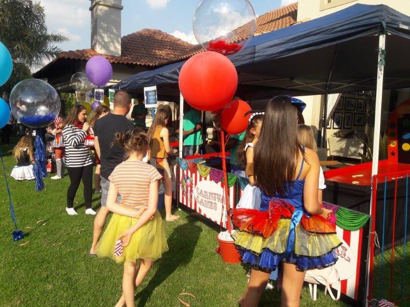 Children in costumes enjoying a festive outdoor party setup