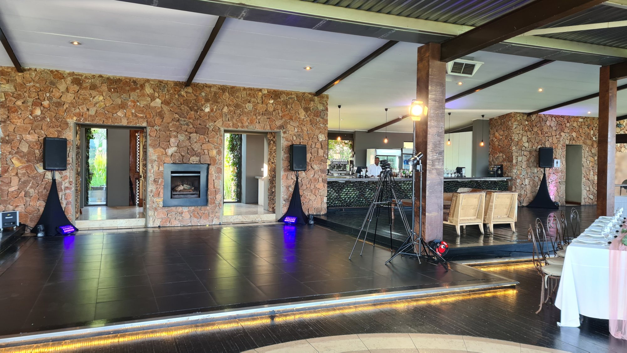 Interior of an elegant event venue with stone walls and bar