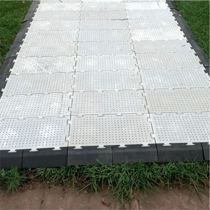 Modular outdoor flooring panels arranged on grass