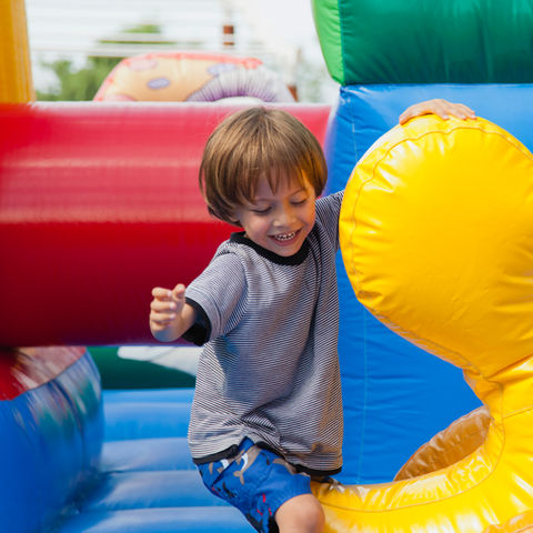 A child playing in a colorful jumping castle