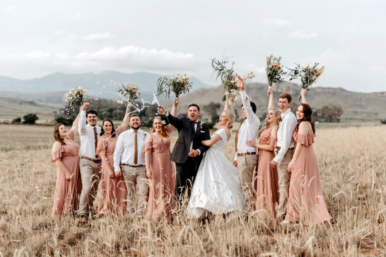 Wedding party celebrating in a field