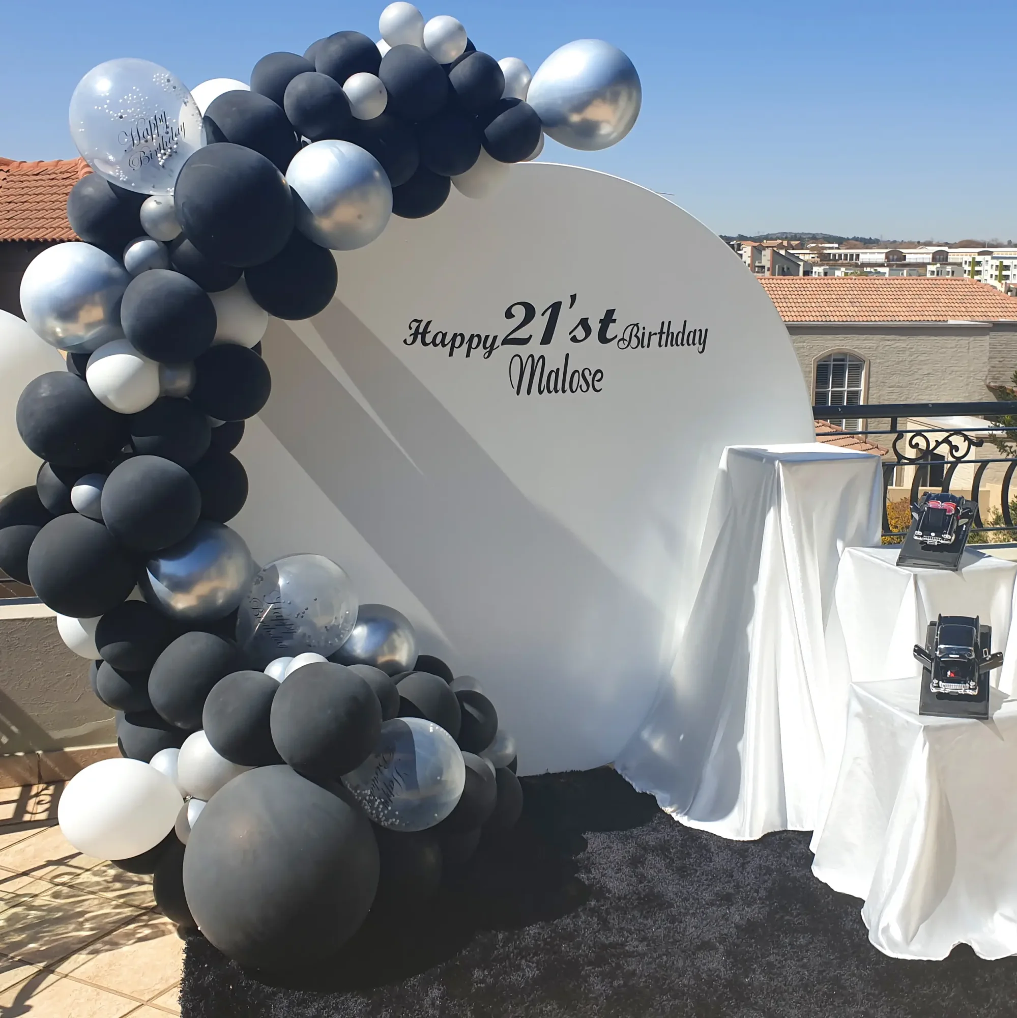 Black and silver balloon arch for a 21st birthday celebration
