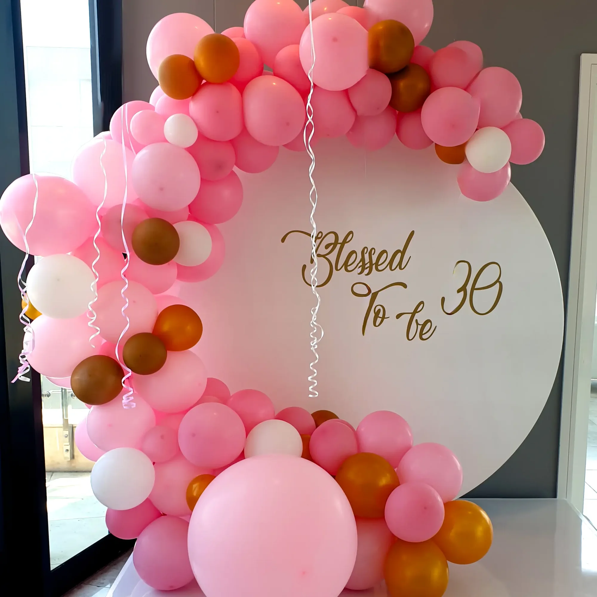 Balloon arch with a sign saying 'Blessed To Be 30'