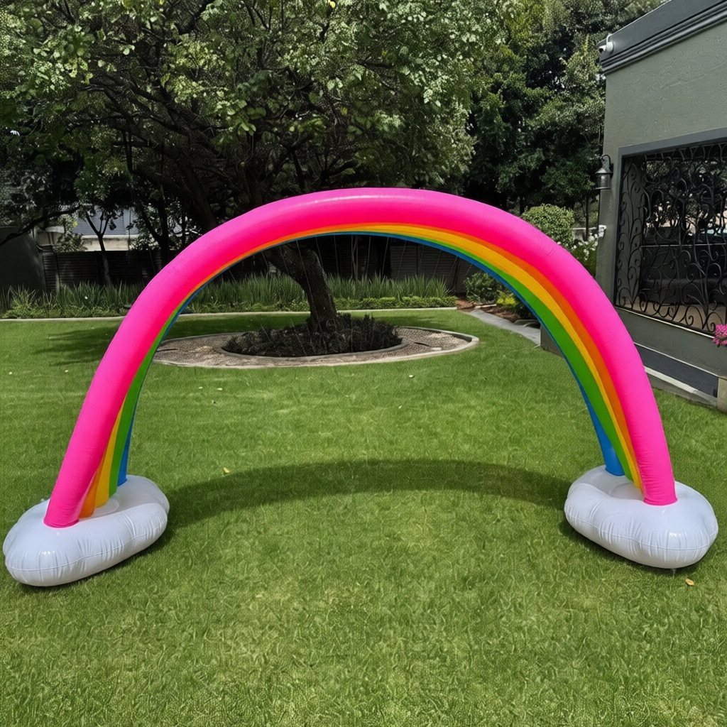 Inflatable rainbow sprinkler with clouds on grass