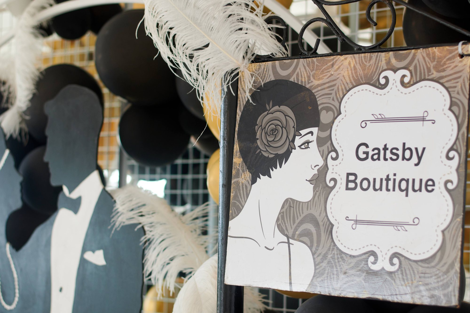 Gatsby Boutique decor with black and gold balloons and a gentleman silhouette