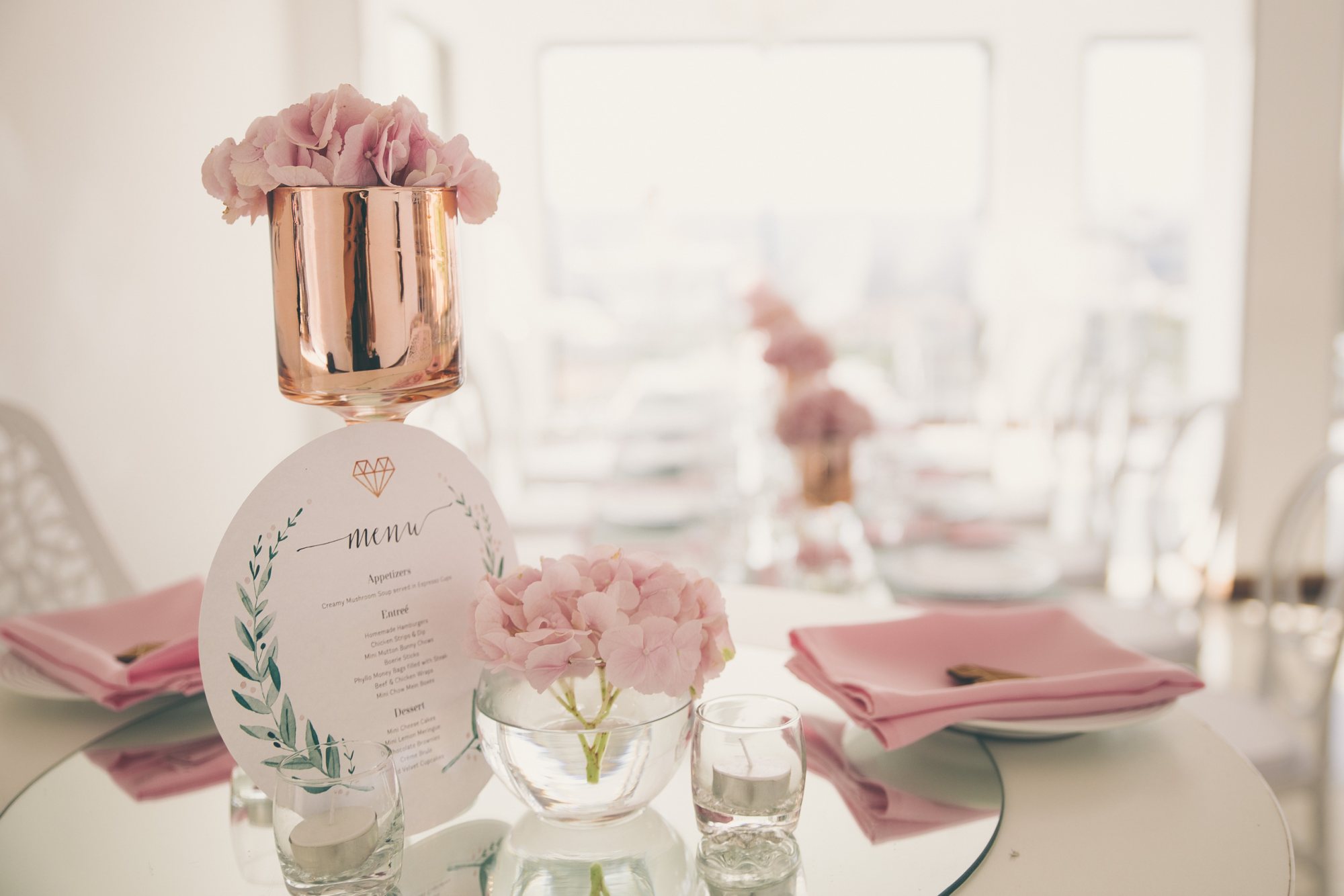Elegant table setting with pink flowers and menu card