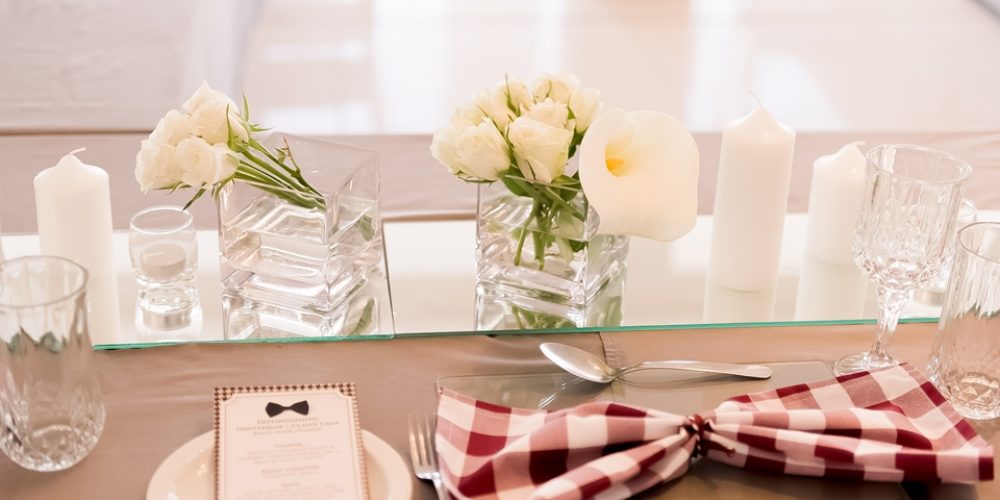 Table set with flowers, candles, and checkered napkins